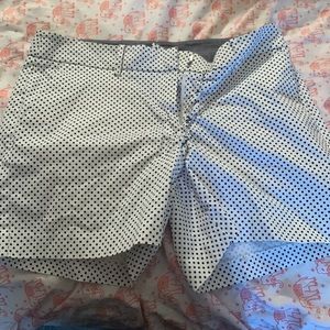 Black dots, white shorts.